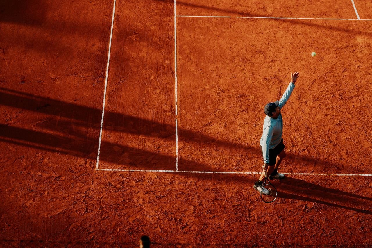 Services Aerial view of a tennis player serving on a clay court in Buenos Aires, Argentina.
